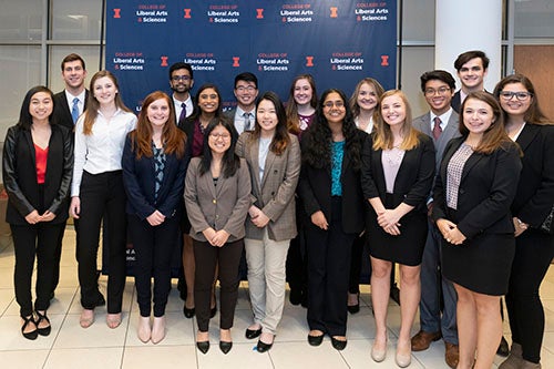 LAS Leaders pose in front of a College of LAS backdrop