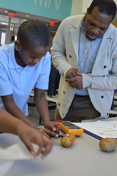 Jerrod Henderson works with a student at the St. Elmo Brady STEM Academy, an organization he co-founded. It's one of the main reasons Henderson received the 2014-2015 Campus Award for Excellence in Public Engagement.
