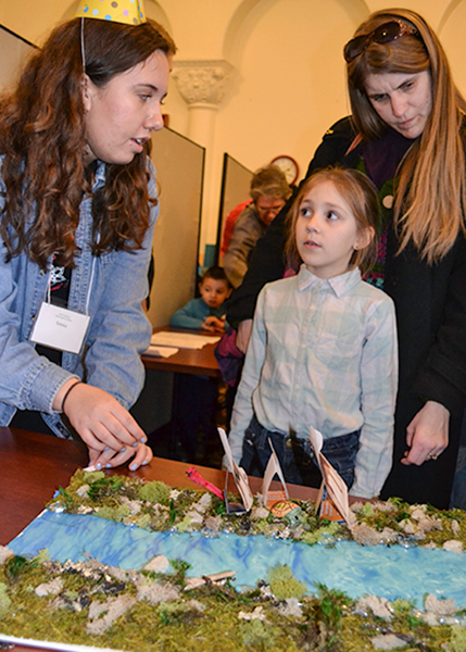 Illinois sophomore Emily Alameda does the Crossing the River activity with a local youngster at the Riddle Mania station. (Photo by Elizabeth Innes.) 