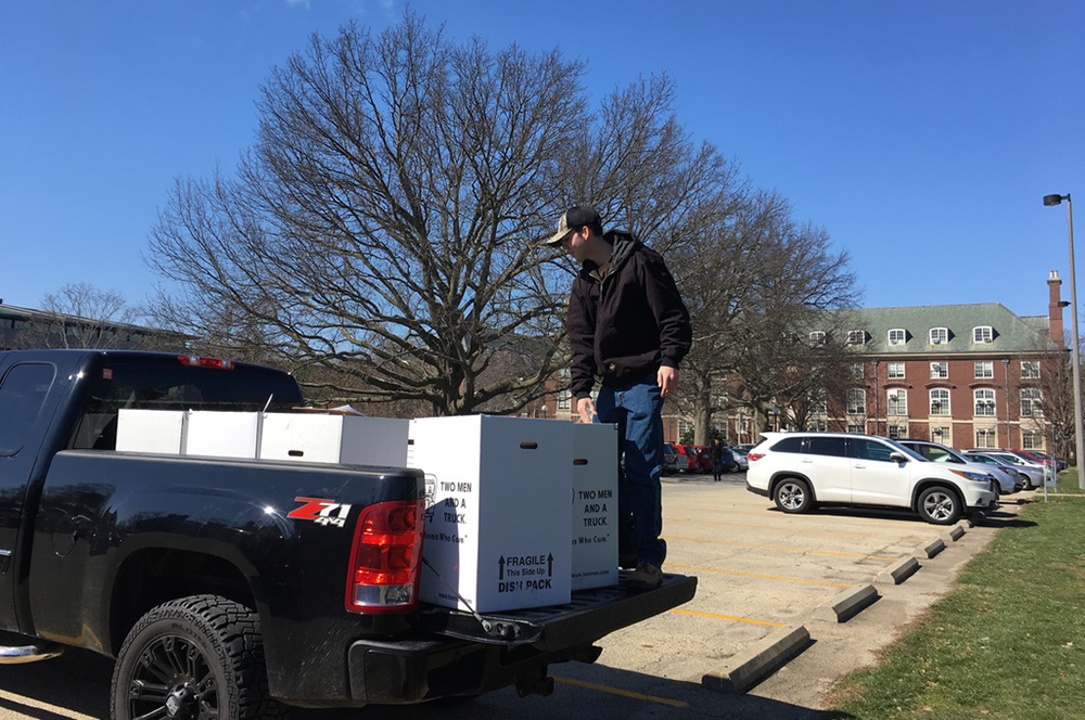 Conner Weber, a student at Illinois, unloads boxes for a food drive inspired in part by a history class on the Great Depression. (Photo courtesy of Leslie Reagan.) 
