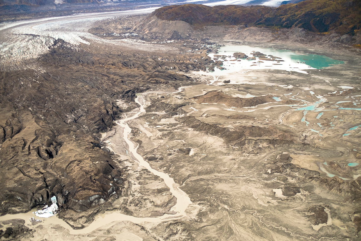 A stream runs along the toe of Kaskawulsh Glacer in Kluane National Park, Yukon. In 2016, this channel allowed the glacier’s meltwater to drain in a different direction than normal, resulting in the Slims River water being rerouted to a different river system. (Photo by Dan Shugar, University of Washington Tacoma.) 