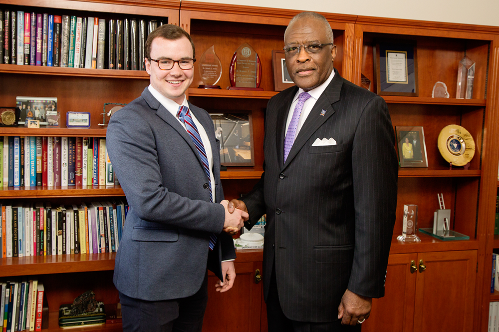 Thomas Dowling, left, a junior at the University of Illinois, congratulated by Chancellor Robert Jones. A Chicago native, Dowling was selected from a nationwide pool of nominees as one of 62 Truman Scholars.