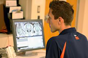 Austin Mudd, whose study linked choline and fetal brain development, works with an MRI image. (Image courtesy of the College of ACES.) 