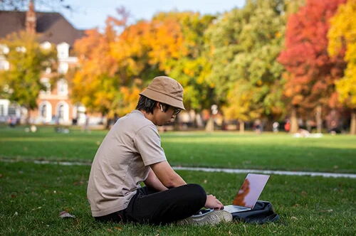 Student using laptop outside