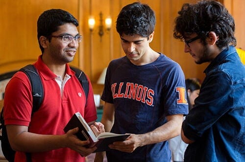Students talking over a book