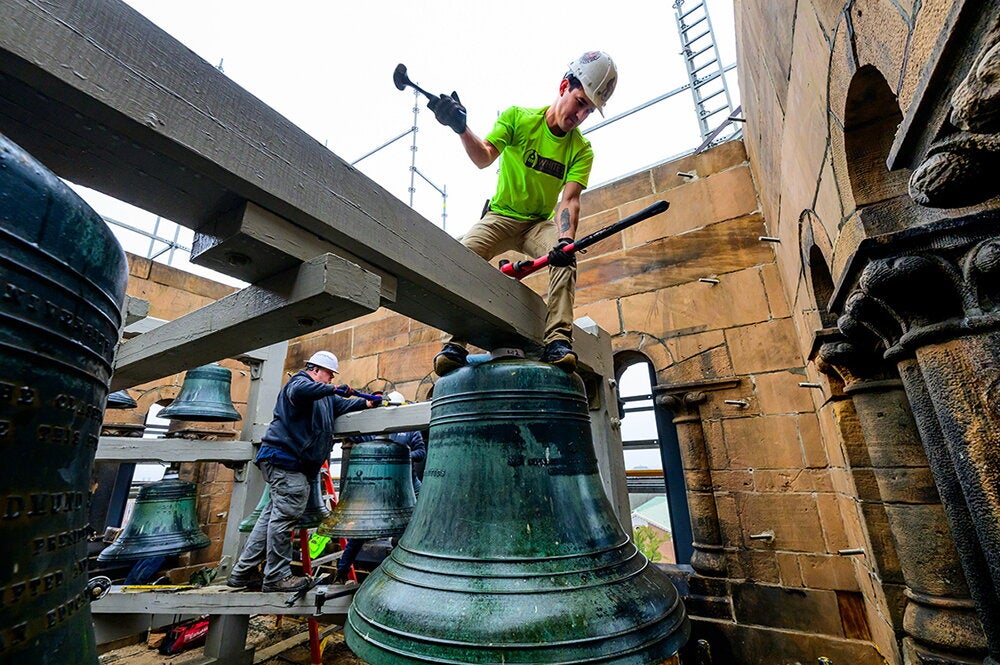 A worker removes one of the Altgeld bells