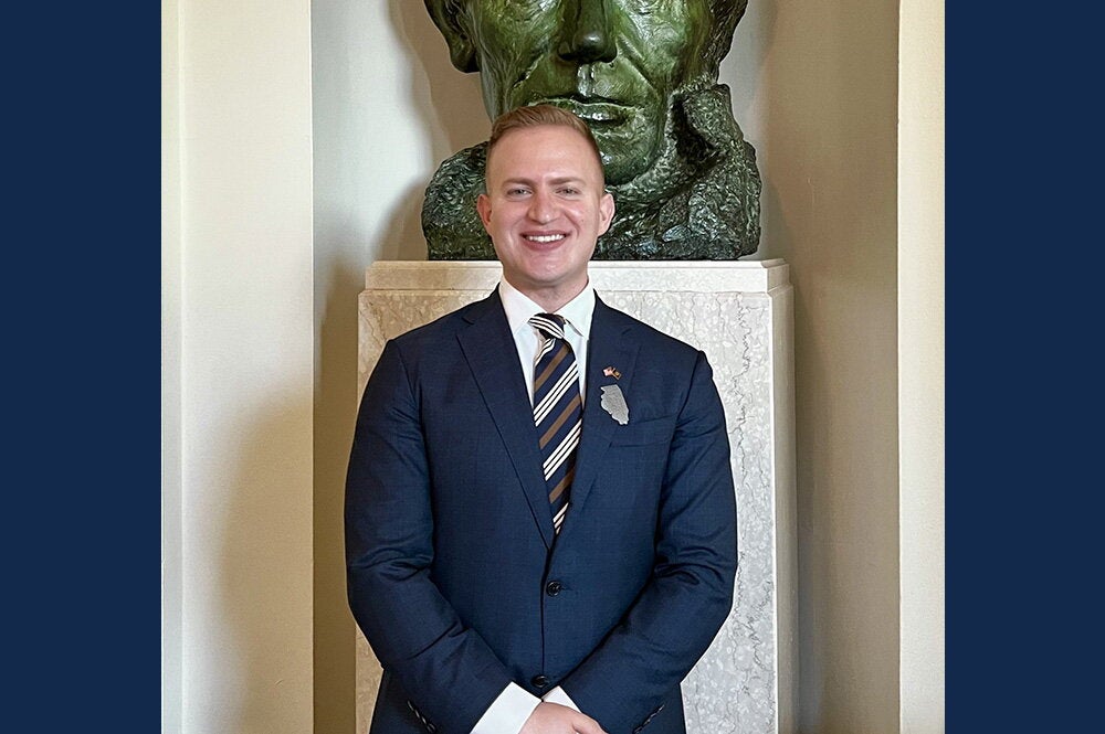 Adham Sahloul stands in front of a bust of Abraham Lincoln