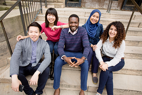 A group of international students on the steps of Foellinger Auditorium