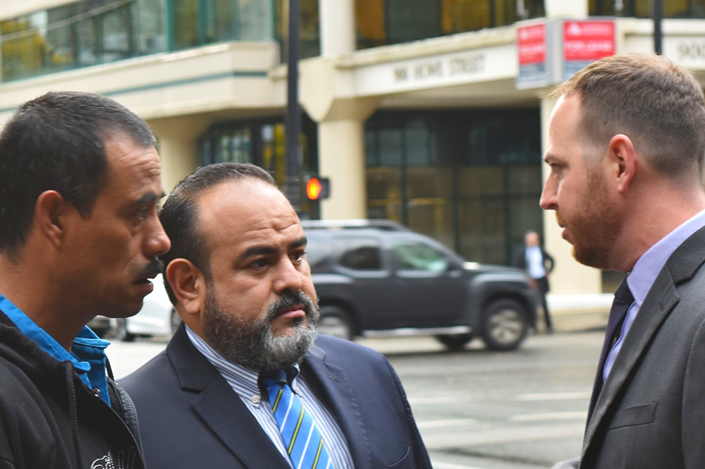 Matt Eisenbrandt, right, speaks to a Guatemalan client and his lawyer in Vancouver prior to a court hearing concerning a Canadian mining company. (Image courtesy of Matt Eisenbrandt.) 