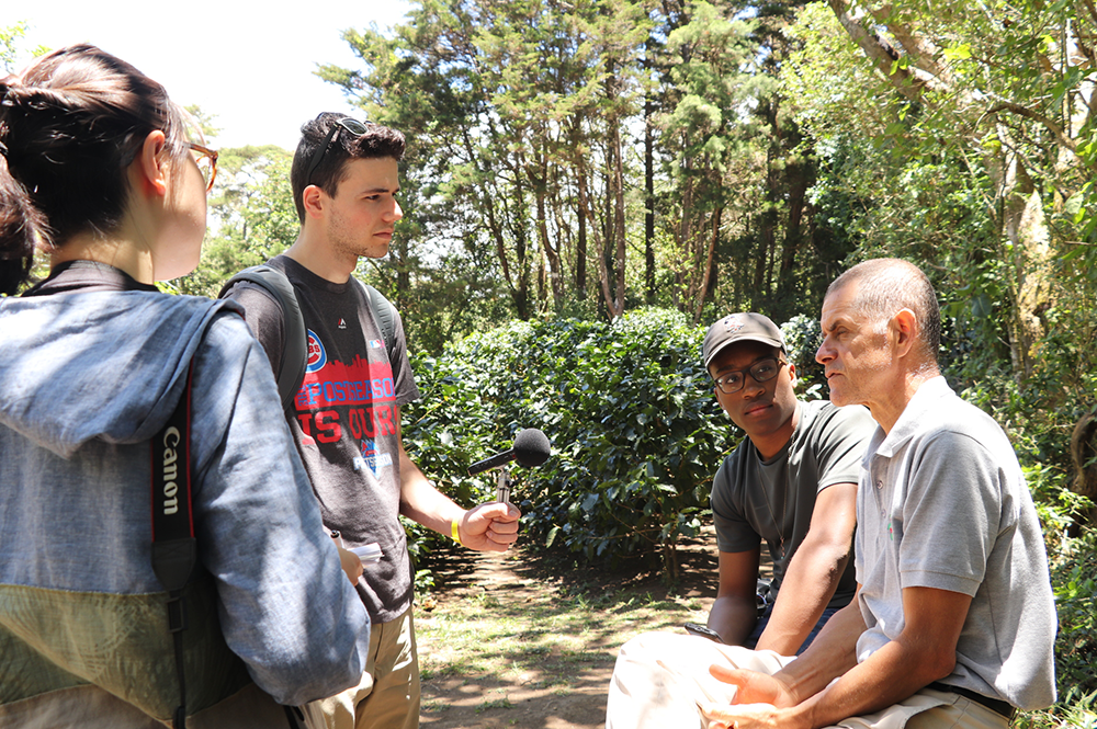 From left: Cara Feng, Ryan Grosso, and David Wilkerson-Lindsey interview Monteverde resident Guillermo Vargas about the diversified farm he runs in cooperation with his extended family in Costa Rica. (Photo by Edmond Fitzgerald.) 