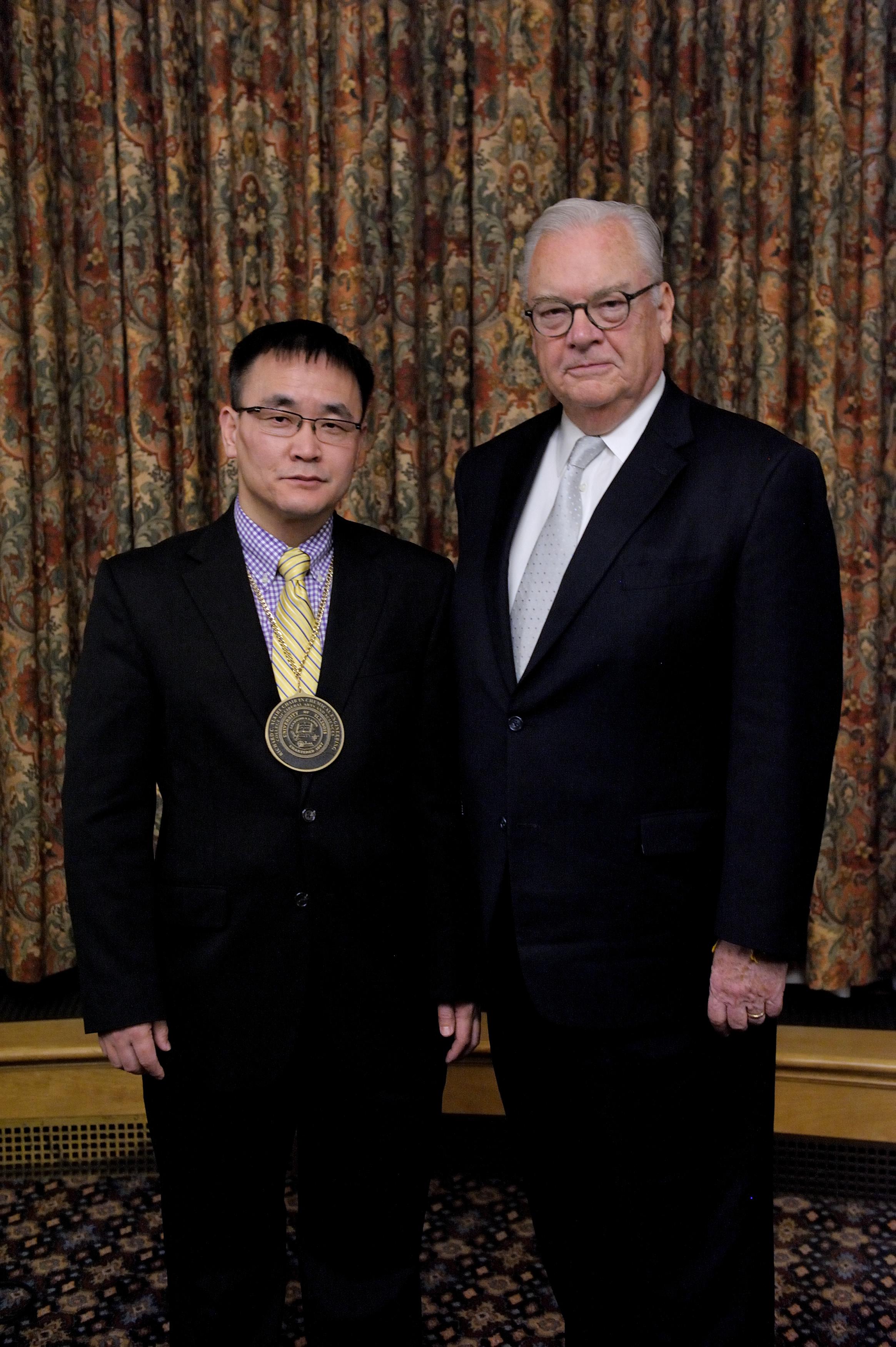 Hong Yang, left, and Richard Alkire pose for a photo after Yang was formally named the Richard C. Alkire Chair in Chemical Engineering. (Thompson-McClellan.) 